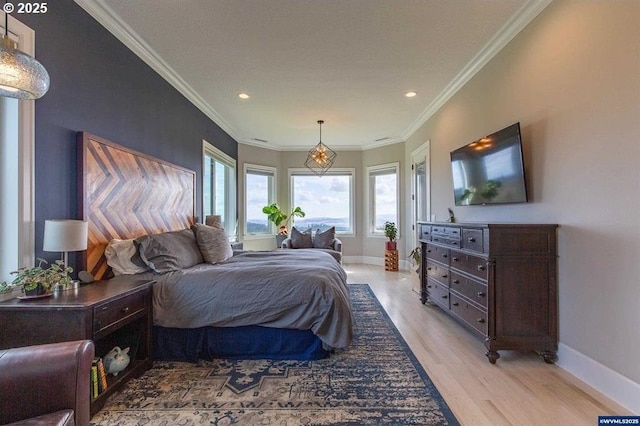 bedroom featuring ornamental molding, baseboards, and light wood-type flooring