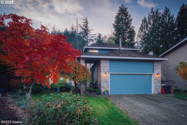 view of front facade with a garage and a yard