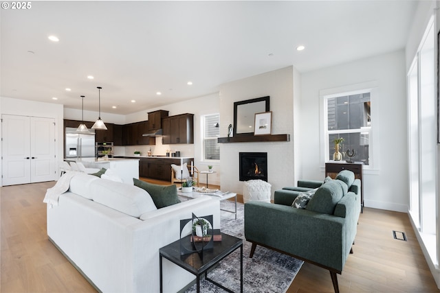 310 W Fir Loop, Washougal, WA 98671 - living room with healthy amount of natural light, recessed lighting, light wood-style floors, and a fireplace