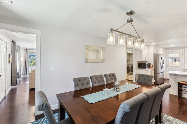 dining room with recessed lighting, washing machine and dryer, dark wood-style flooring, and a healthy amount of sunlight