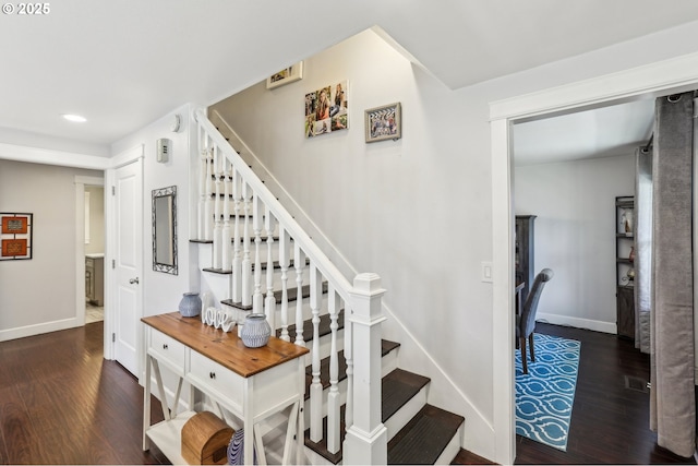 stairs featuring wood finished floors and baseboards