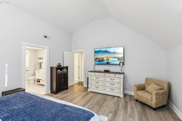 bedroom with visible vents, high vaulted ceiling, ensuite bath, light wood-style floors, and baseboards