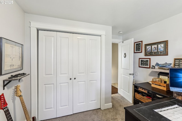 bedroom featuring a closet and light carpet