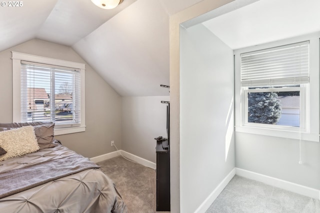 bedroom featuring vaulted ceiling, baseboards, and carpet floors