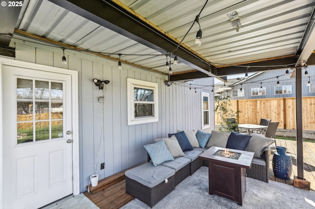 view of patio / terrace with an outdoor living space with a fire pit and fence