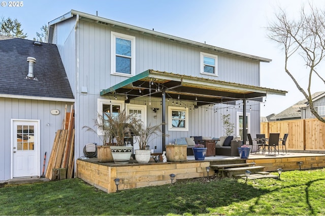 rear view of house featuring fence