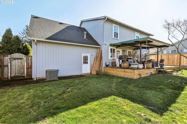 rear view of house with fence, central AC unit, a yard, a patio, and a gate