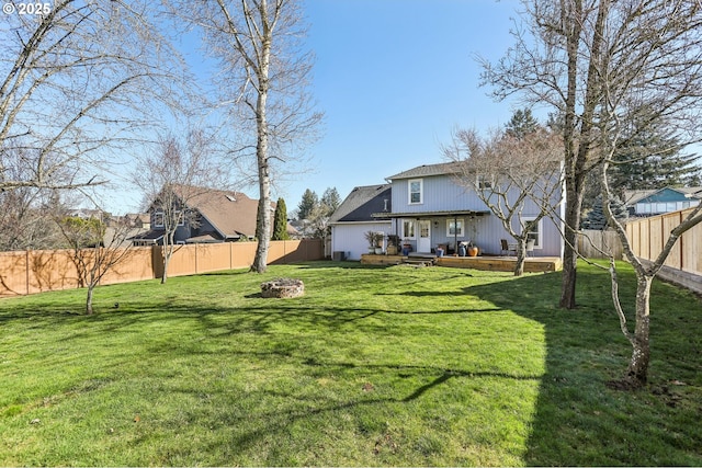 view of yard featuring a deck and a fenced backyard