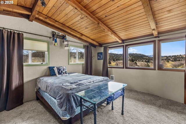 bedroom featuring vaulted ceiling with beams, a textured wall, and carpet floors