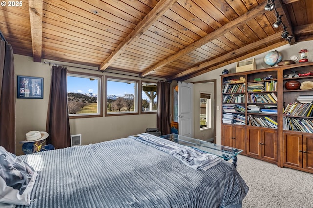 bedroom with rail lighting, carpet flooring, wood ceiling, and vaulted ceiling with beams