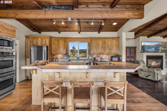 kitchen featuring wood ceiling, tasteful backsplash, and appliances with stainless steel finishes