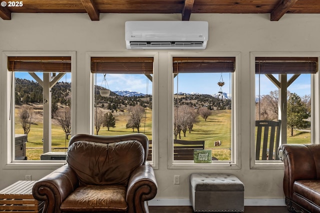 sunroom with beamed ceiling, a healthy amount of sunlight, and an AC wall unit