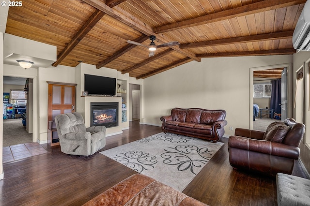 living room featuring a wall mounted AC, lofted ceiling with beams, wood finished floors, a glass covered fireplace, and wooden ceiling