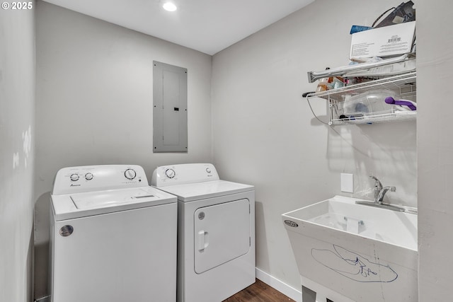 laundry room featuring laundry area, dark wood-type flooring, baseboards, washer and dryer, and electric panel