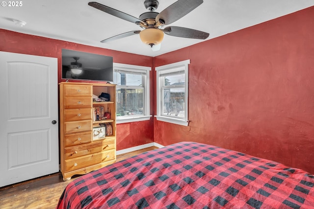 bedroom with ceiling fan and wood finished floors