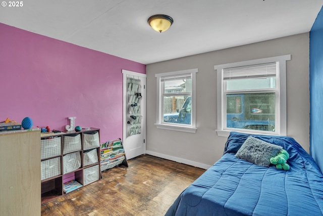 bedroom with baseboards and wood finished floors