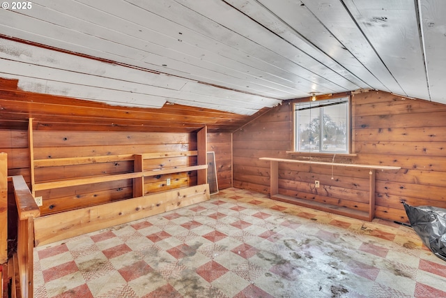 bonus room with lofted ceiling, wooden ceiling, wooden walls, and tile patterned floors