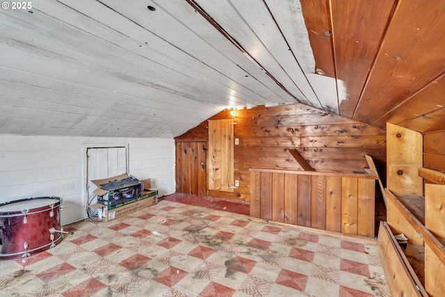 bonus room featuring vaulted ceiling, wood ceiling, wood walls, and tile patterned floors