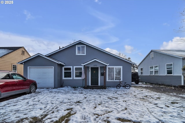 bungalow-style house featuring an attached garage and stucco siding