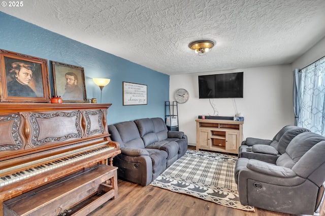 living area with a textured ceiling and wood finished floors