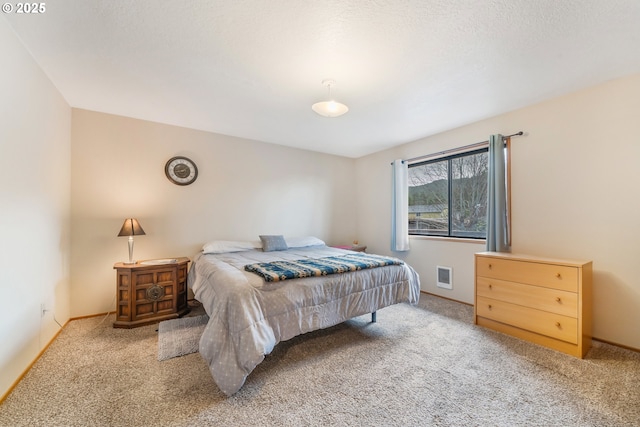 bedroom with visible vents, baseboards, and carpet floors