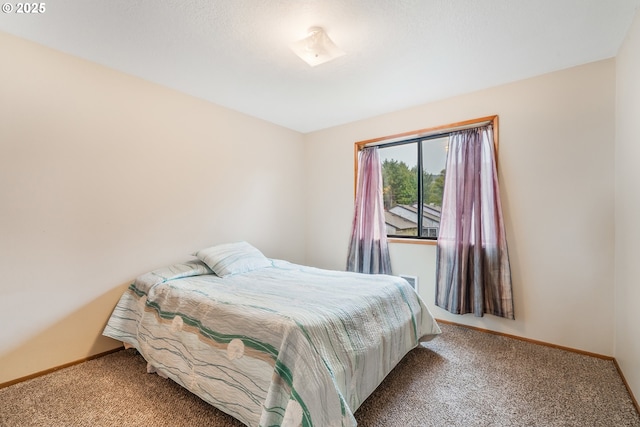 carpeted bedroom with baseboards