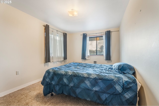 carpeted bedroom featuring baseboards