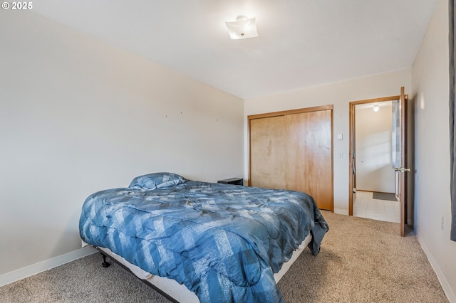 bedroom featuring baseboards, carpet floors, and a closet