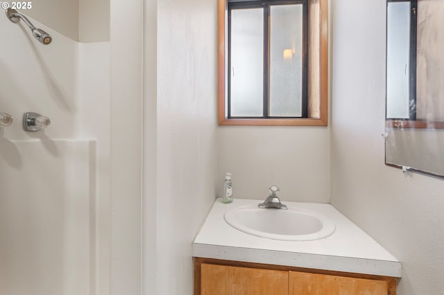 bathroom featuring vanity and walk in shower