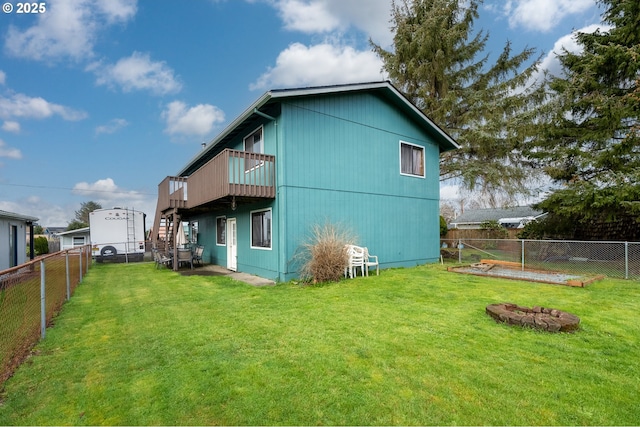 rear view of property with a deck, a lawn, stairway, and a fenced backyard