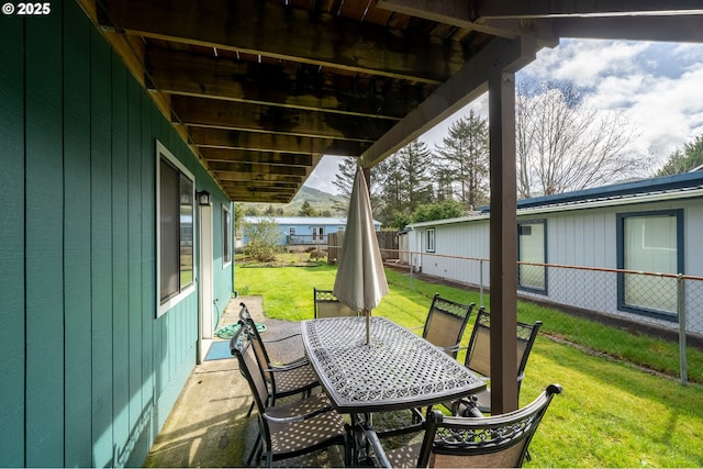 view of patio featuring outdoor dining area and fence