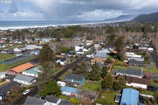 drone / aerial view with a water view and a residential view