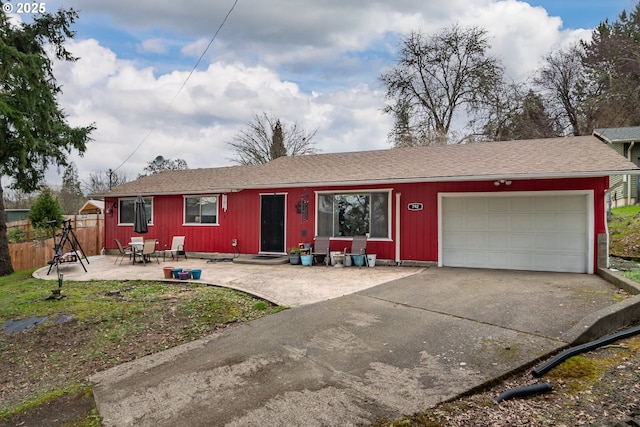 single story home featuring a garage, a patio area, fence, and driveway