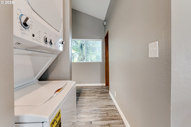 284 Waite St, Eugene, OR 97402 - laundry area with light wood-type flooring, estacked washer and dryer, and baseboards