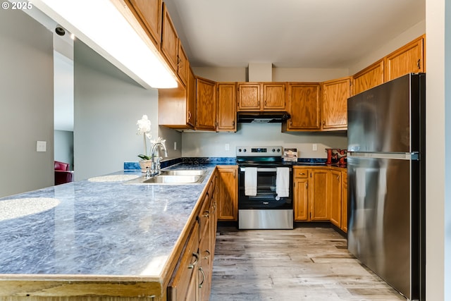 284 Waite St, Eugene, OR 97402 - kitchen featuring stainless steel appliances, under cabinet range hood, a sink, a peninsula, and brown cabinetry