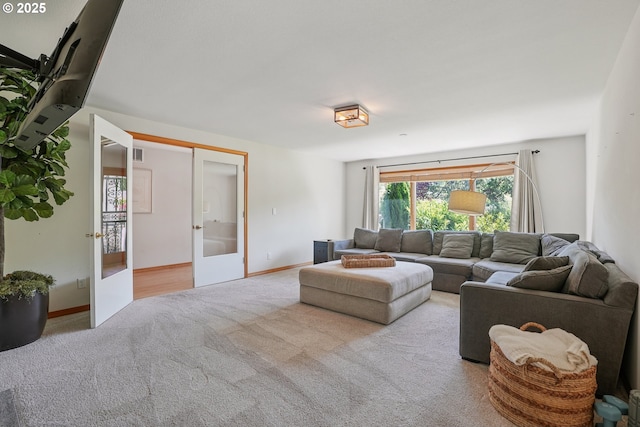8895 SW Bohmann Pkwy, Portland, OR 97223 - carpeted living room featuring french doors and baseboards