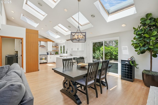 8895 SW Bohmann Pkwy, Portland, OR 97223 - dining space with a skylight, lofted ceiling, light wood-type flooring, a chandelier, and recessed lighting