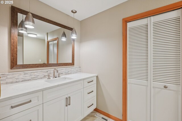 8895 SW Bohmann Pkwy, Portland, OR 97223 - bathroom featuring a closet, vanity, backsplash, and baseboards