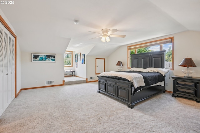 8895 SW Bohmann Pkwy, Portland, OR 97223 - bedroom featuring vaulted ceiling, carpet flooring, multiple windows, a closet, and baseboards