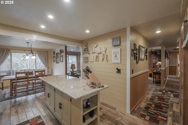 kitchen with dark wood-style flooring, open shelves, recessed lighting, a center island, and hanging light fixtures