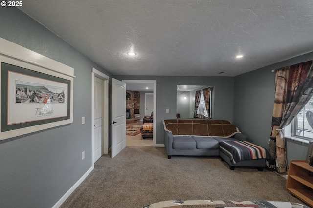 living room with carpet floors, recessed lighting, a textured ceiling, and baseboards