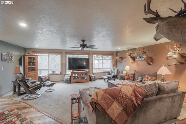 living room with recessed lighting, ceiling fan, a textured ceiling, wood finished floors, and baseboards