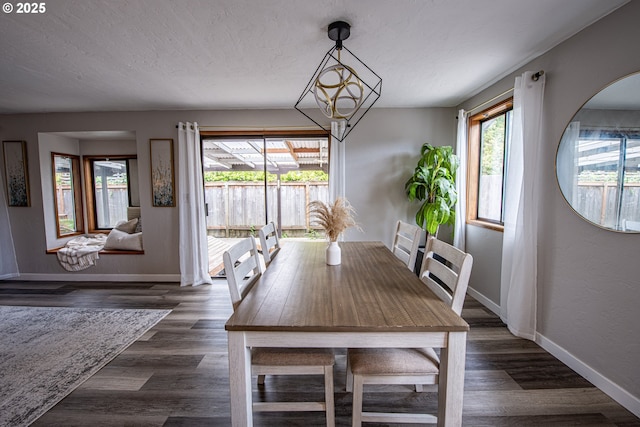 3308 Honeywood St, Eugene, OR 97408 - dining area with baseboards, dark wood-style floors, and a chandelier