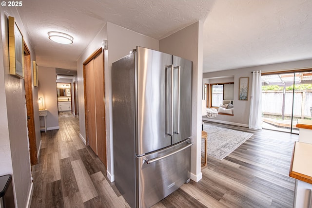 3308 Honeywood St, Eugene, OR 97408 - kitchen featuring high end refrigerator, dark wood-type flooring, baseboards, and a textured ceiling
