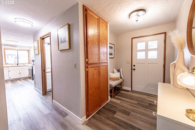 3308 Honeywood St, Eugene, OR 97408 - entryway featuring a textured ceiling, dark wood-style floors, a textured wall, and baseboards