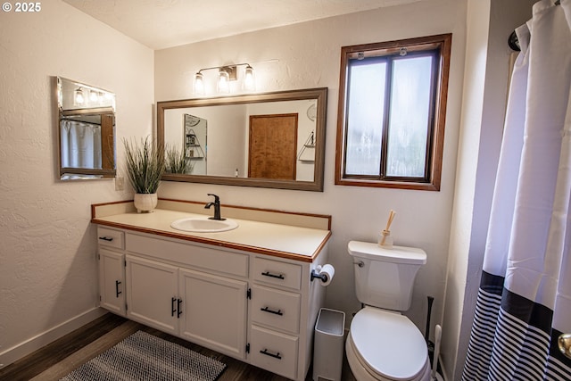 3308 Honeywood St, Eugene, OR 97408 - bathroom with wood finished floors, vanity, toilet, and a textured wall