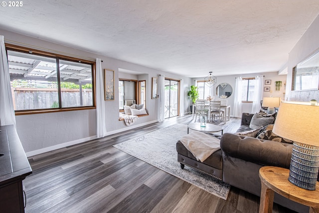 3308 Honeywood St, Eugene, OR 97408 - living room featuring a textured ceiling, wood finished floors, baseboards, and a chandelier