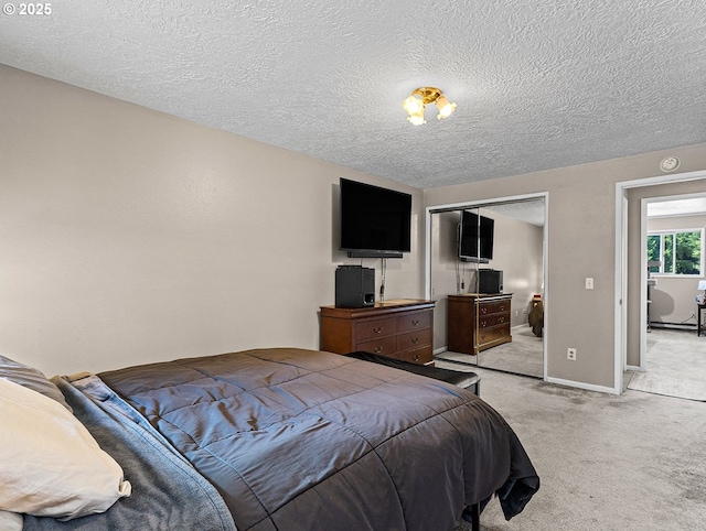 3311 SE 1st St, Gresham, OR 97080 - bedroom featuring a textured ceiling, light carpet, a closet, and baseboards