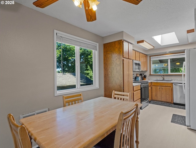3311 SE 1st St, Gresham, OR 97080 - dining room featuring a skylight and a textured ceiling