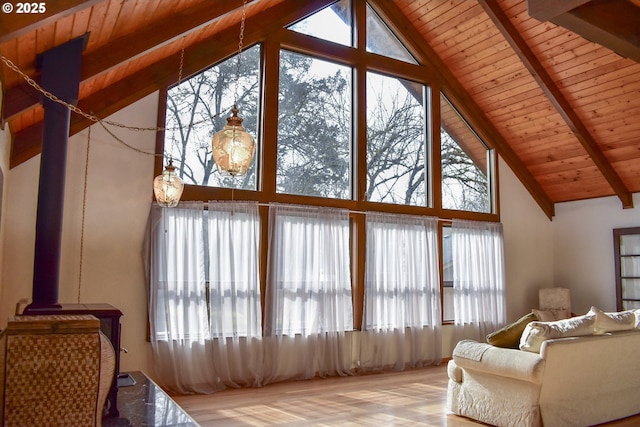 living room with wooden ceiling, high vaulted ceiling, and beam ceiling